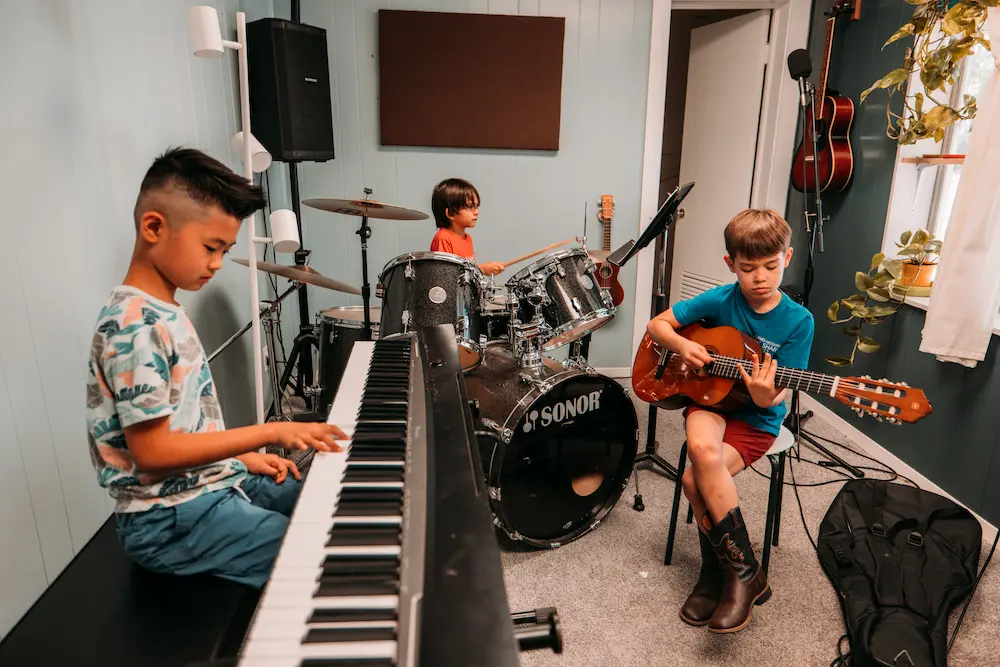 Music students practicing together in a band rehearsal space